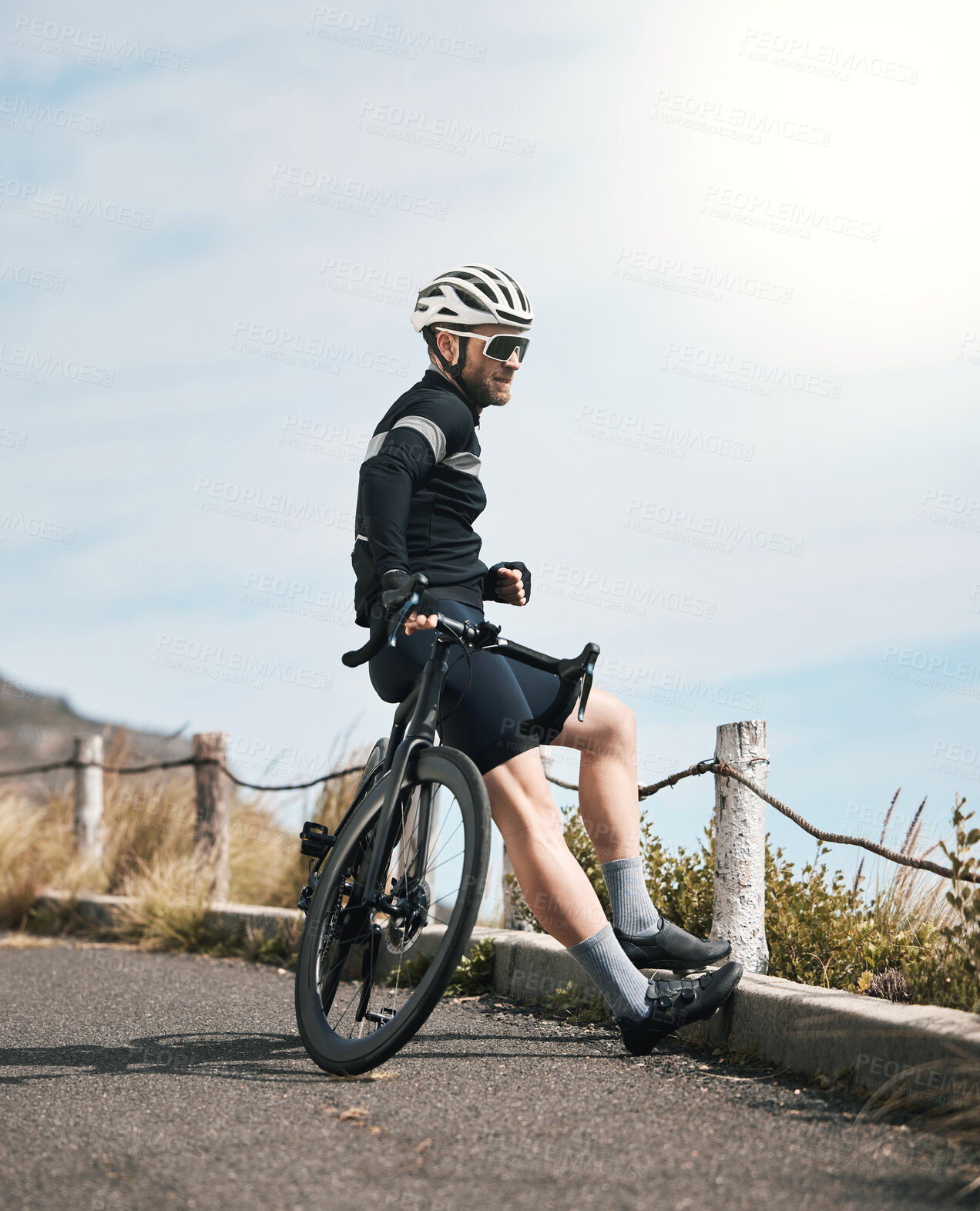 Buy stock photo Full length shot of a handsome mature man taking a break while cycling outdoors