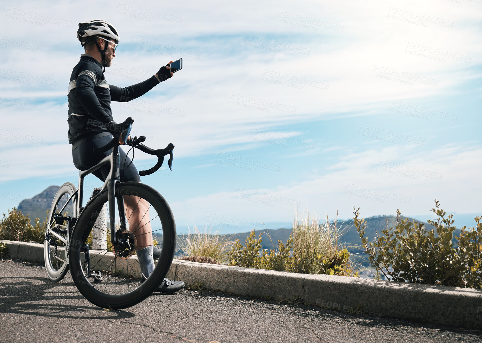 Buy stock photo Cropped shot of a handsome mature man taking photographs while cycling outdoors