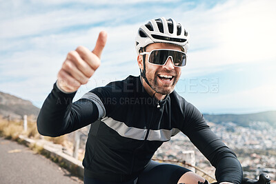 Buy stock photo Cropped shot of a handsome mature man gesturing thumbs up while cycling outdoors