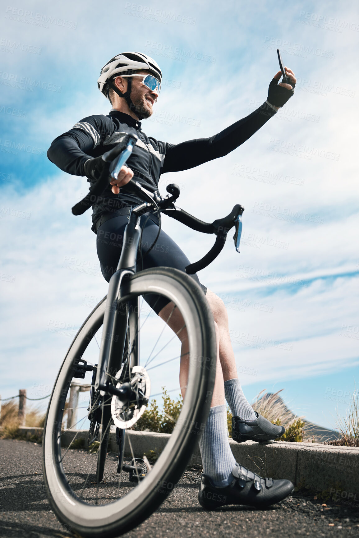 Buy stock photo Cropped shot of a handsome mature man taking photographs while cycling outdoors