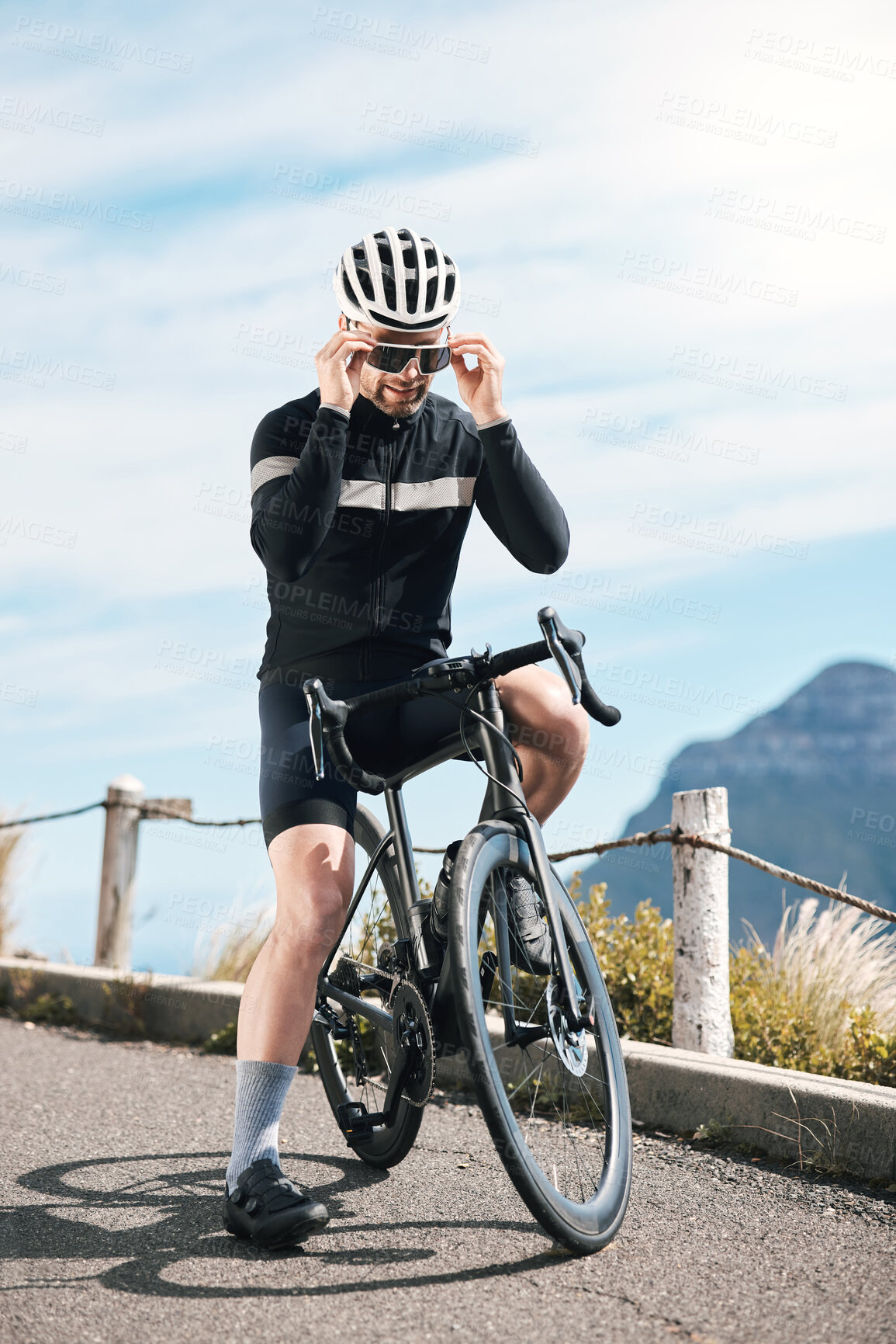 Buy stock photo Full length shot of a handsome mature man taking a break while cycling outdoors
