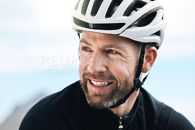 Buy stock photo Cropped shot of a handsome mature man taking a break while cycling outdoors