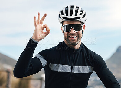 Buy stock photo Cropped shot of a handsome mature man gesturing a-okay while cycling outdoors