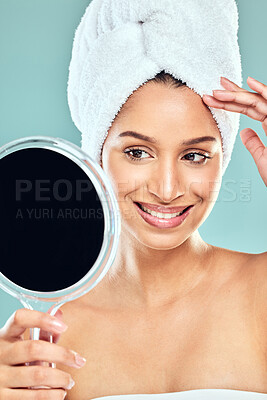 Buy stock photo Shot of a beautiful young woman admiring herself in the mirror against a studio background