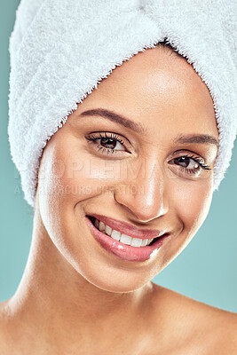 Buy stock photo Portrait, woman and happy for skincare in blue background, beauty and routine for healthy skin. Face, smile of model and towel on head, makeup for cosmetics or dermatology by wellness in studio