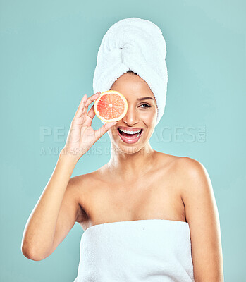 Buy stock photo Woman, orange and citrus for skincare in studio, eco friendly and vitamin c to hydrate skin. Female person, glow and organic beauty or facial treatment after shower, cosmetics and blue background