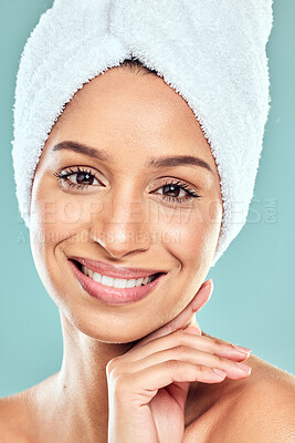 Buy stock photo Woman, portrait and beauty with towel in studio for wellness, health and face products. Female person, skincare and cosmetics for results for haircare, dermatology or glowing skin in blue background
