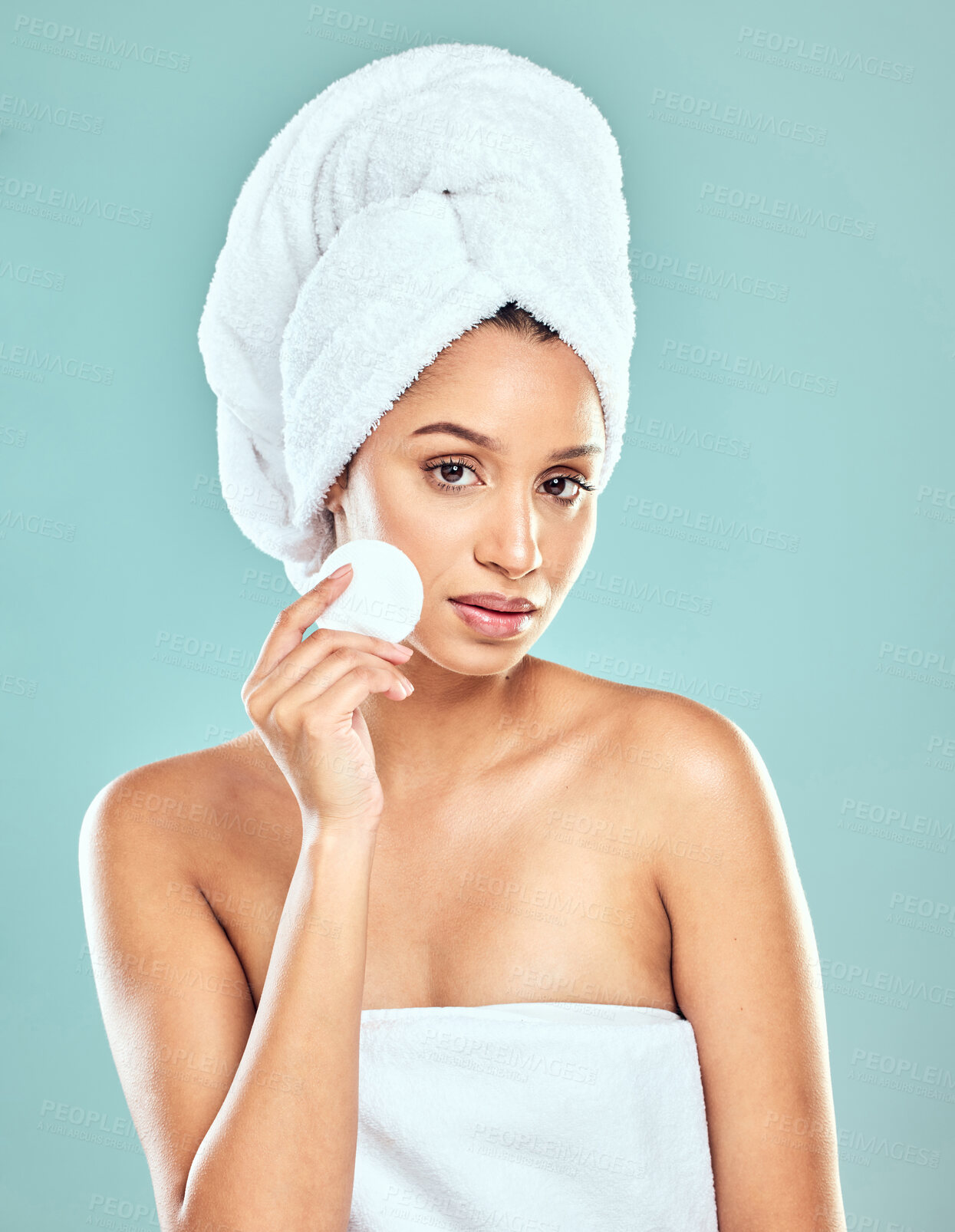 Buy stock photo Portrait, woman and towel in studio for skincare, cleansing or refreshed on blue background. Spa treatment, cotton pad and female person with swab for wellness, cleaning or soft skin from dermatology