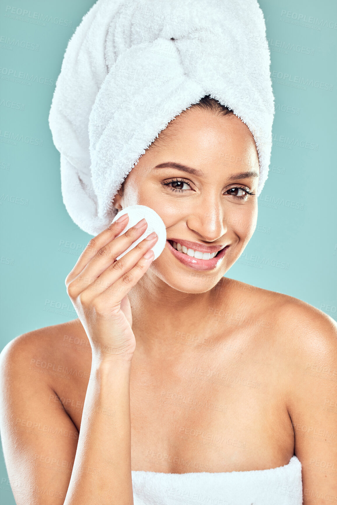 Buy stock photo Portrait, happy woman or towel in studio for skincare, cleansing or refreshed on blue background. Spa treatment, smile and female person with swab for wellness, cleaning or soft skin from dermatology