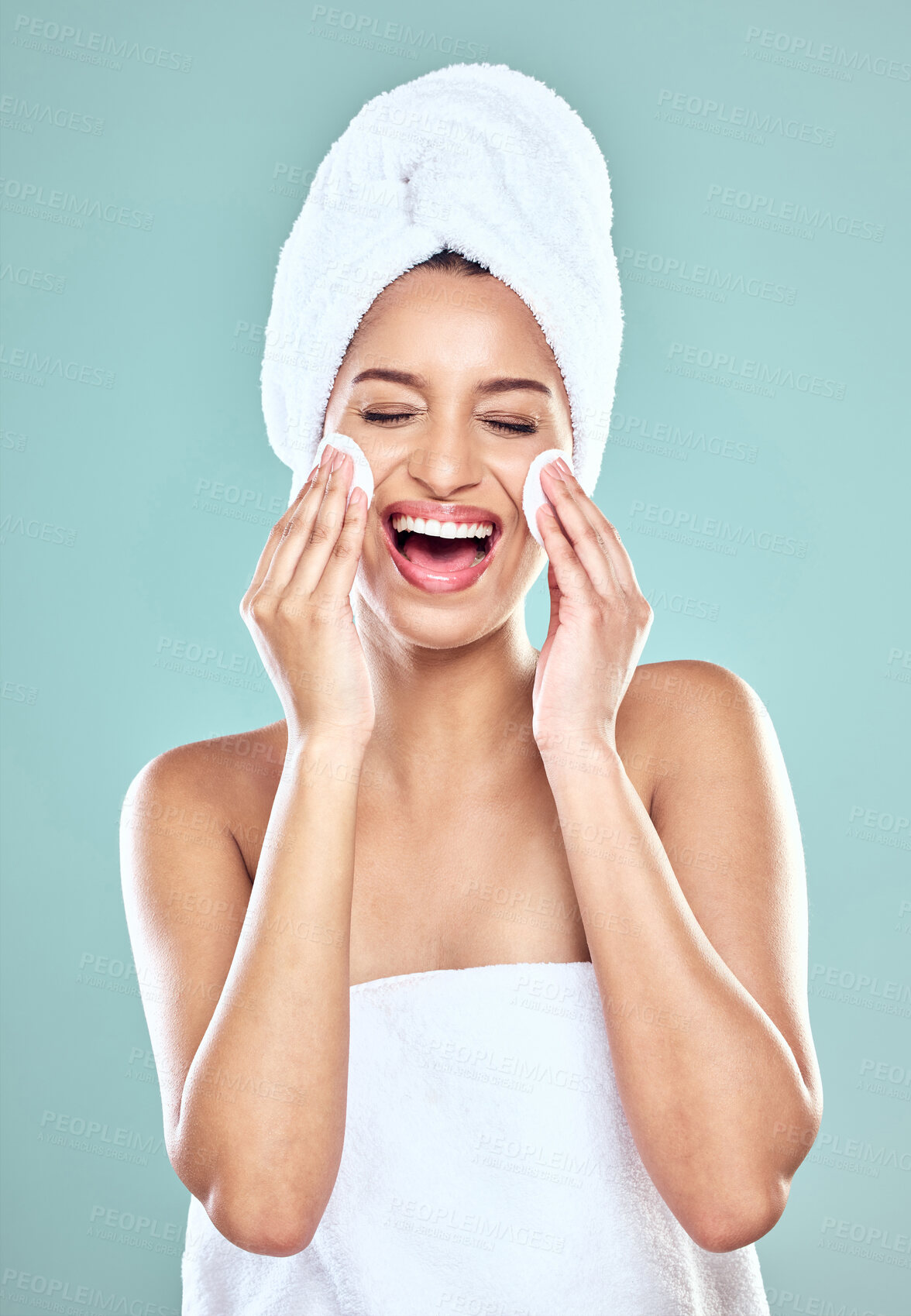 Buy stock photo Smile, towel and woman for skincare or cleansing, cotton pads and pamper for blue background. Cosmetology, smile or hygiene routine for spot control, retinol or hyaluronic acid for female person