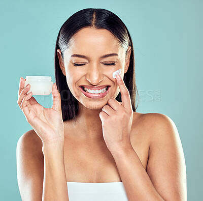 Buy stock photo Smile, jar and woman with face cream for glow, skin transformation and anti aging results in studio. Model girl, dermatology and facial lotion with collagen for skincare and beauty by blue background