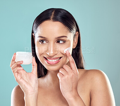 Buy stock photo Happy, jar and woman with face cream for glow, facial transformation and beauty in studio. Model girl, dermatology and sunscreen with collagen for skincare and anti aging benefits by blue background