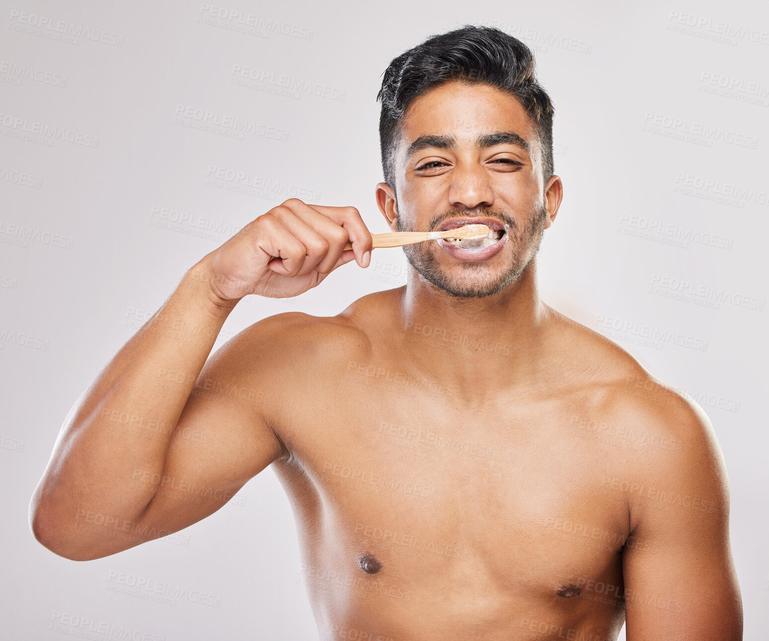 Buy stock photo Man, brushing teeth and portrait in studio for hygiene, clean or routine on white background. Indian male person, dental care or plaque treatment with toothbrush for grooming, wellness or freshness