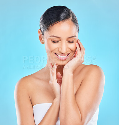 Buy stock photo Skincare, beauty or happy Indian woman with natural facial shine with dermatology cosmetics in studio. Cleaning, blue background and face of proud girl model with healthy glow results and wellness