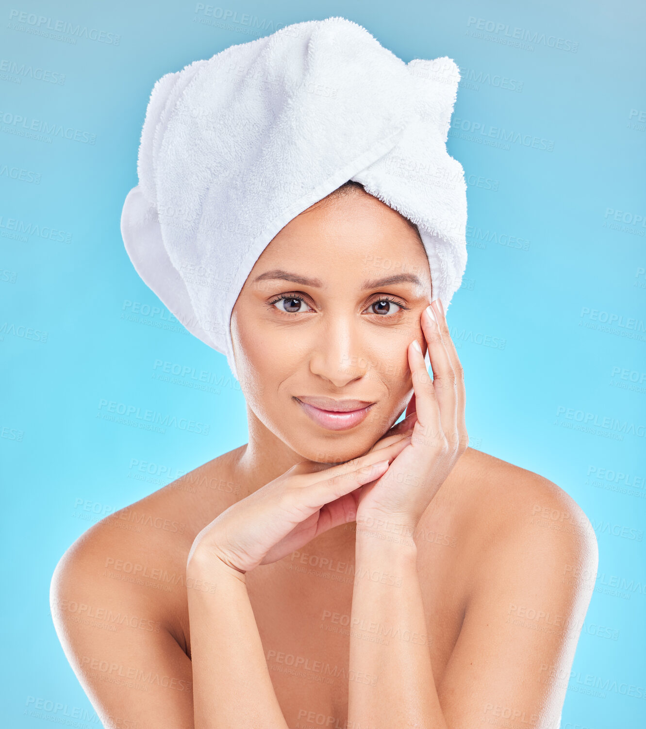 Buy stock photo Skincare, towel and portrait of Indian woman with natural facial shine with dermatology cosmetics in studio. Beauty, blue background and clean face of girl model with healthy glow results or wellness