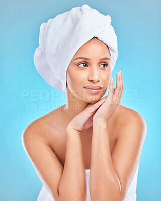 Buy stock photo Studio shot of an attractive young woman posing with a towel on her head against a blue background