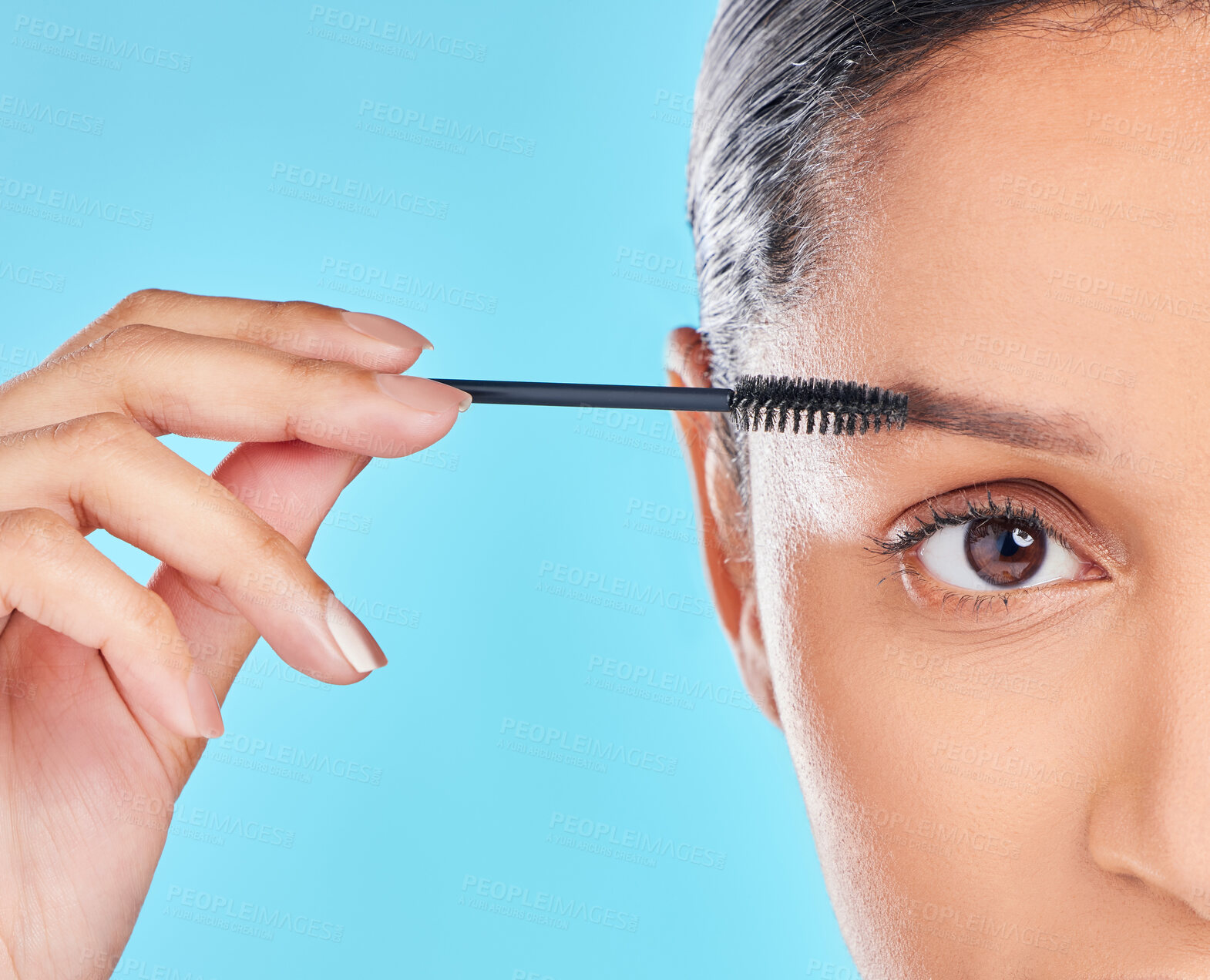 Buy stock photo Portrait, eyebrows and girl with mascara makeup for beauty, cosmetics product or wellness in studio. Woman, model or half face closeup with brush, skincare or application results on blue background