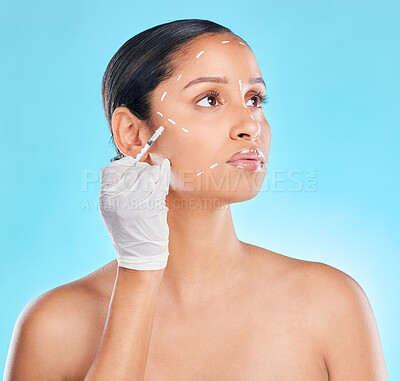 Buy stock photo Studio shot of an attractive young woman having some plastic surgery done against a blue background