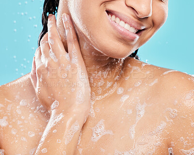 Buy stock photo Shot of an unrecognizable person taking a shower against a blue background