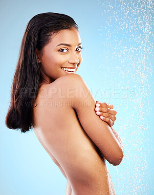 Buy stock photo Shot of a young woman taking a shower against a blue background