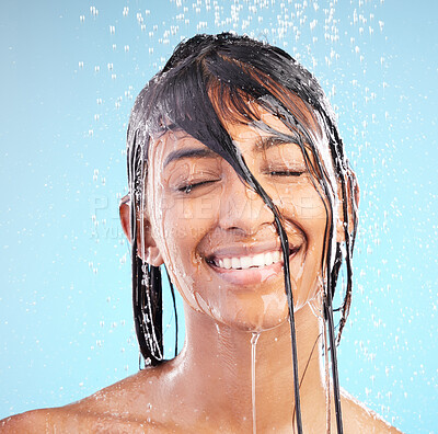 Buy stock photo Happy, shower and woman cleaning hair for health, dermatology and beauty bath. Face, skincare and model in water for fresh hygiene, wash or eyes closed for haircare isolated on blue studio background