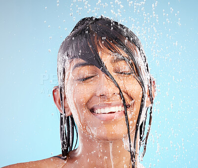 Buy stock photo Beauty, shower and happy woman cleaning hair for health, dermatology and bath with eyes closed. Face, skincare and 
smile of model in water for hygiene or haircare isolated on blue studio background