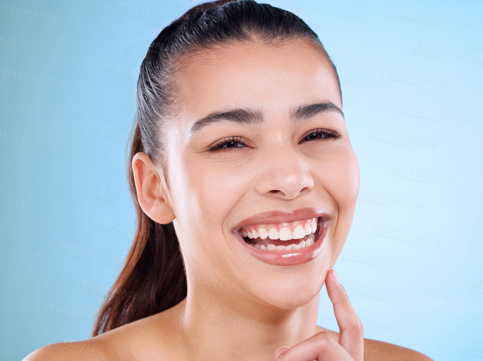 Buy stock photo Happy woman, portrait and skincare with makeup for facial treatment or cosmetics on a blue studio background. Face of female person or young model with smile for dermatology, cosmetology or hygiene