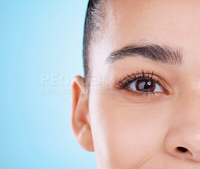 Buy stock photo Studio portrait of an attractive young woman posing against a blue background