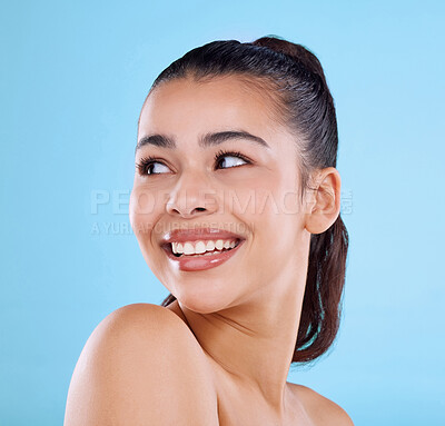 Buy stock photo Studio shot of an attractive young woman posing against a blue background