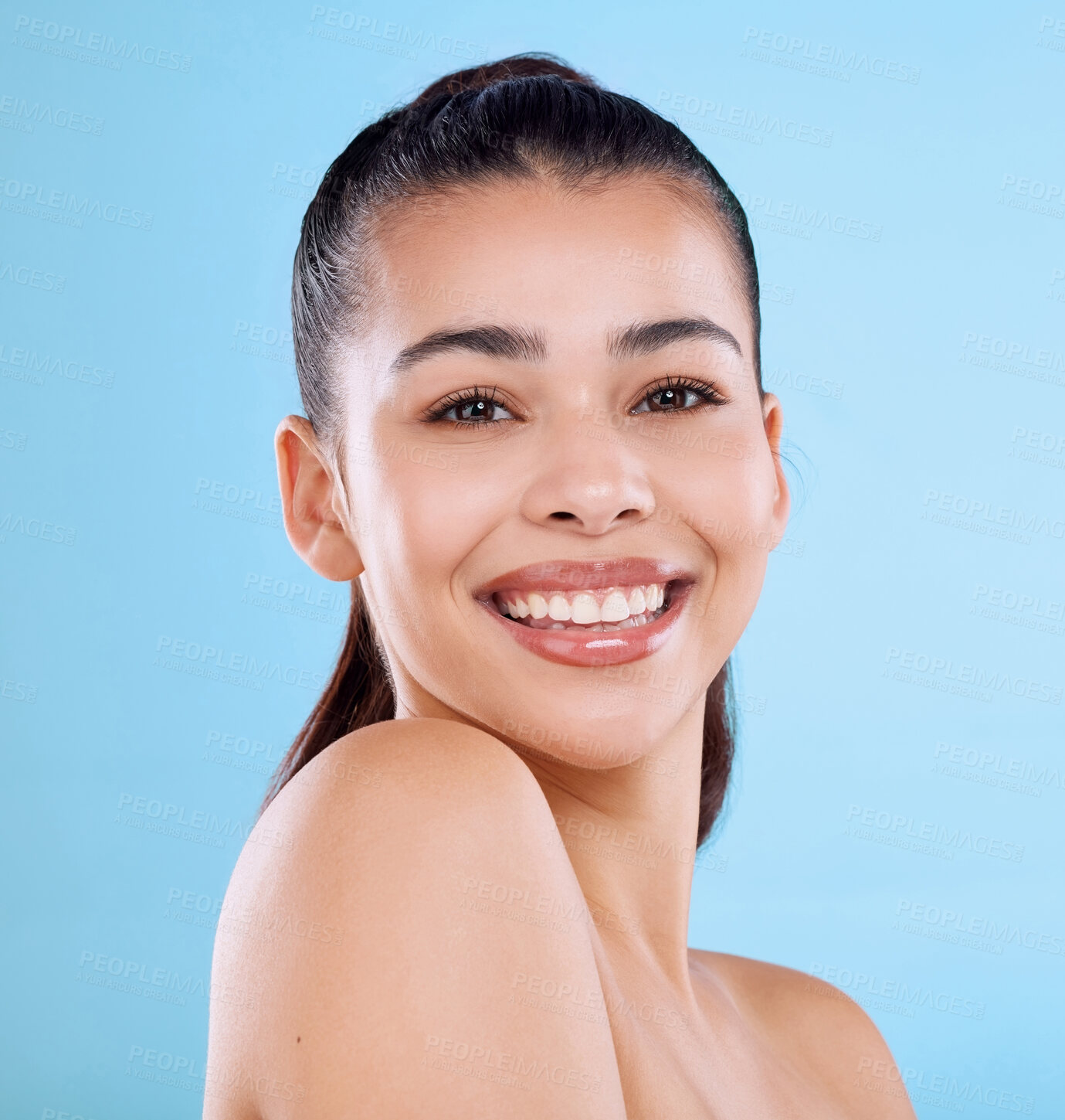 Buy stock photo Skincare, smile and woman with portrait in studio for dermatology, treatment and pride in self care. Happy, female person and face with glow for cosmetics, shine and satisfaction on blue background