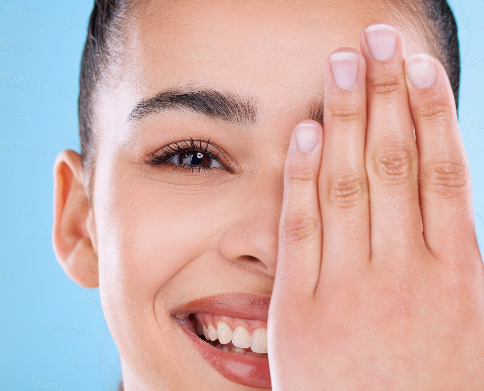 Buy stock photo Girl, cover and portrait in studio for skincare with cosmetics, cosmetology and dermatology for self care with zoom. Woman, smile and beauty with isolated on blue background for wellness and glow.