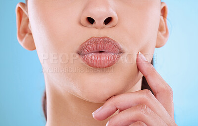 Buy stock photo Studio shot of an unrecognizable young woman posing against a blue background
