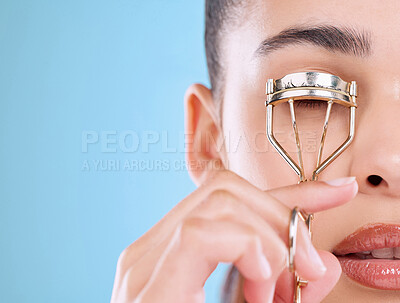 Buy stock photo Face, makeup and woman with eyelash curler for beauty, aesthetic and glow isolated on blue studio background. Facial, metal and model with tools for lashes, skin and cosmetics application closeup