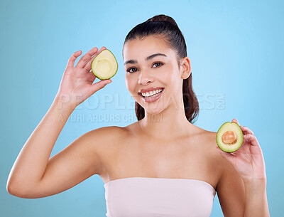 Buy stock photo Girl, portrait and beauty in studio with avocado for healthy diet, skincare or anti aging for glowing skin. Model, hair health or happy with fruit for natural cosmetics or wellness on blue background