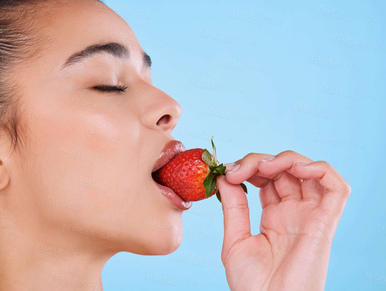 Buy stock photo Woman, eating and strawberry in studio or beauty with healthy diet, skincare and hydration for glowing skin. Model, mockup and detox with fruit for natural cosmetics and wellness on blue background