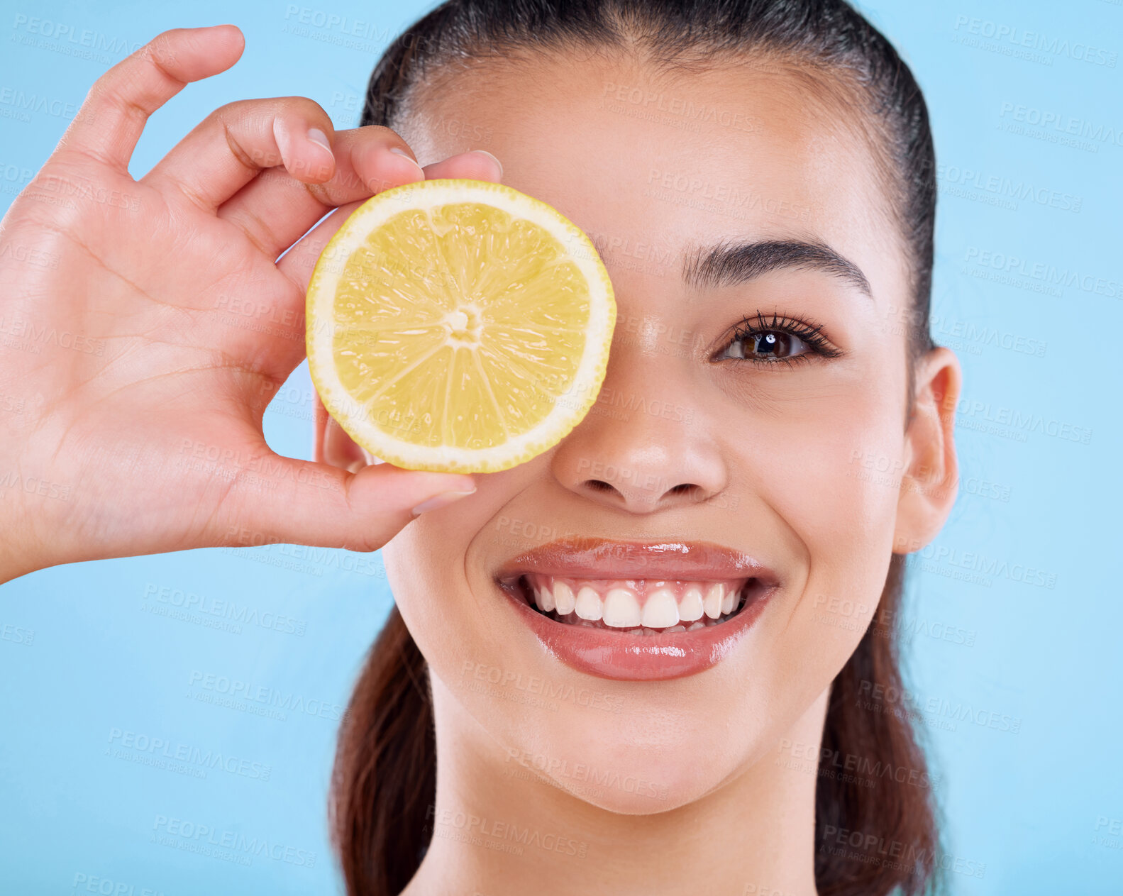 Buy stock photo Woman, portrait and beauty in studio with lemon for healthy diet, skincare and vitamin c for glowing skin. Model, nutrition and happy with fruit for natural cosmetics and wellness on blue background