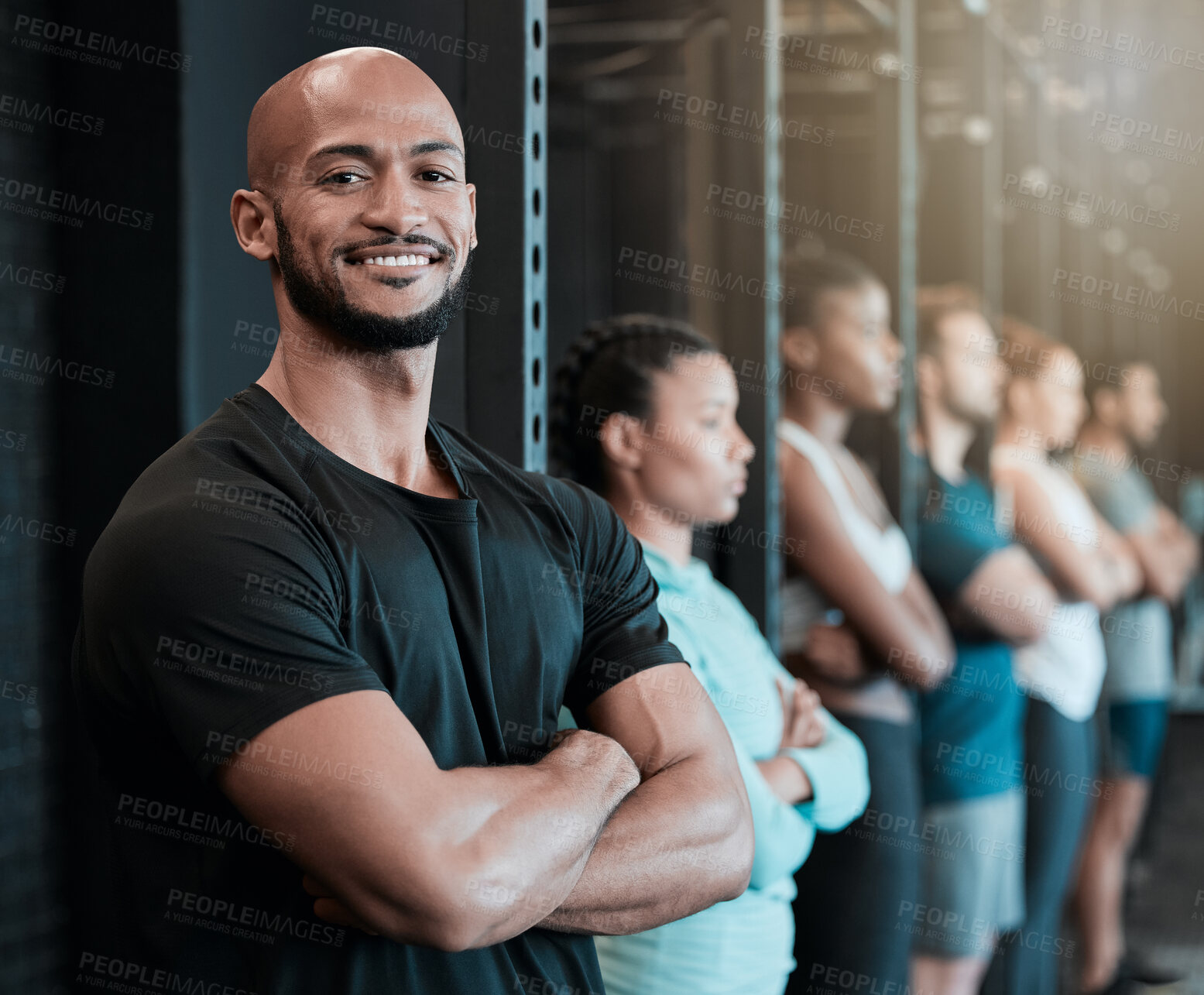 Buy stock photo Fitness, gym and man in row for portrait, confidence and ready for workout in class. Arms crossed, personal trainer and smile in training center for exercise, wellness and determination for growth