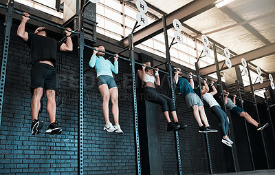 Buy stock photo Shot of a group of people completing pull ups together