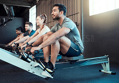 Buy stock photo Show of a group of people rowing together at the gym