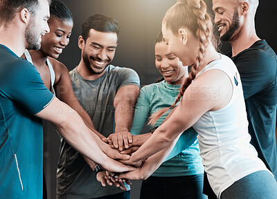Buy stock photo Shot of a group of friends with their hands stacked in motivation at the gym