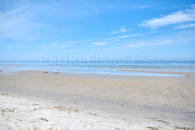Buy stock photo Beautiful, natural and landscape view of the beach and blue sky over the horizon with copy space. A peaceful and calm scene of endless sandy water of the sea or ocean at low tide during the day