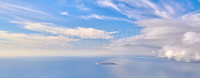 Buy stock photo Beautiful, calm and quiet view of the ocean and clouds in blue sky with a small island and copy space background. Landscape of a cloudy atmosphere and climate in a natural environment during the day