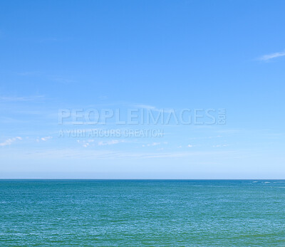 Buy stock photo Beautiful, calm and quiet view of the beach, ocean and sea against a clear blue sky copy space background on a sunny day. Peaceful, scenic and tranquil landscape to enjoy a relaxing coastal getaway