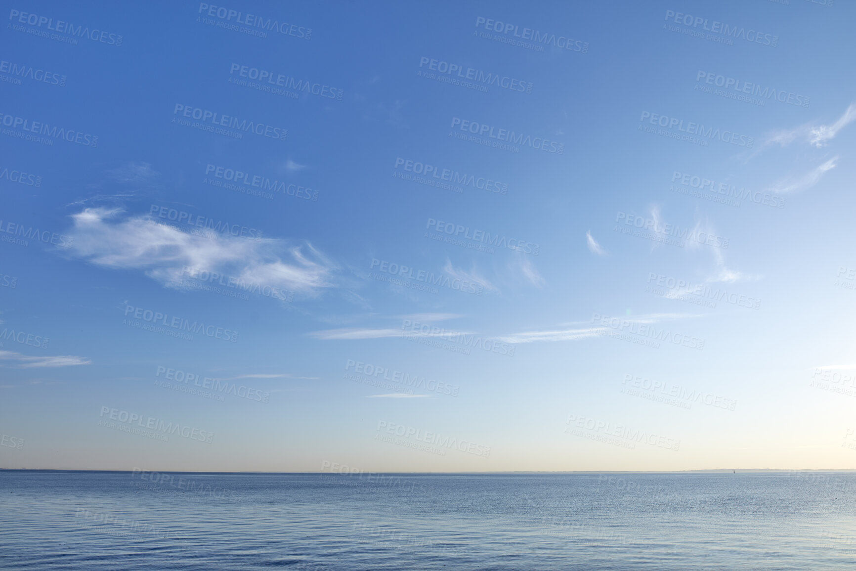 Buy stock photo Beautiful, calm and quiet view of the beach, ocean and sea against a blue sky copy space background on a sunny day outside. Peaceful, scenic and tranquil landscape to enjoy a relaxing coastal getaway