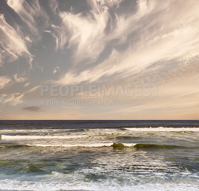 Buy stock photo Colorful sky, sea waves and beautiful beach view with tides and currents under a natural horizon on a cold morning with copy space. A quiet and serene ocean scene in nature during the evening