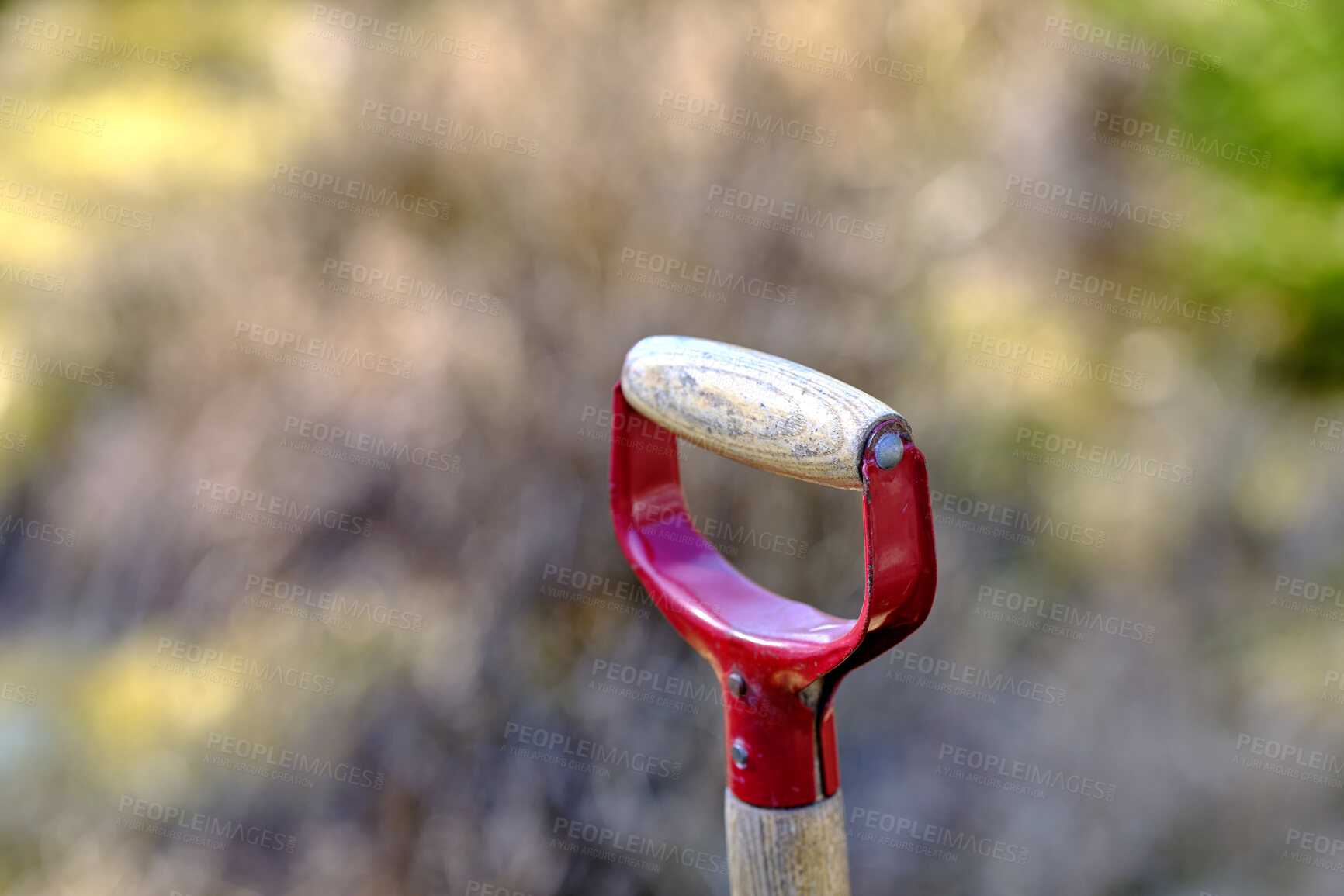 Buy stock photo Closeup of wooden shovel in a garden or field with copy space. Zoom in on macro details, patterns and shape of a gardening tool ready to be used for digging. Macro details of a spade in the ground 