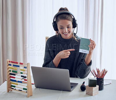 Buy stock photo Shot of a young teaching an online lesson with her laptop at home