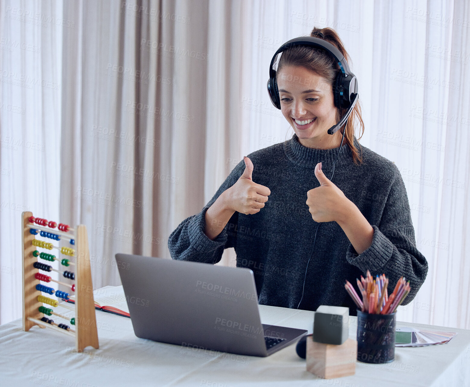 Buy stock photo Shot of a young teaching an online lesson with her laptop at home