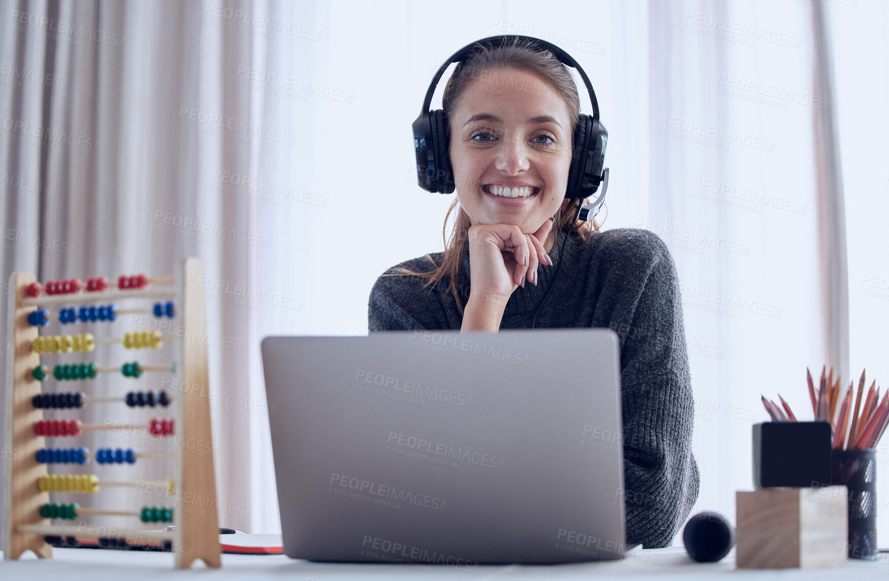 Buy stock photo Shot of a young teaching an online lesson with her laptop at home