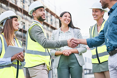 Buy stock photo Shot of a team of builders shaking hands on a construction site outside